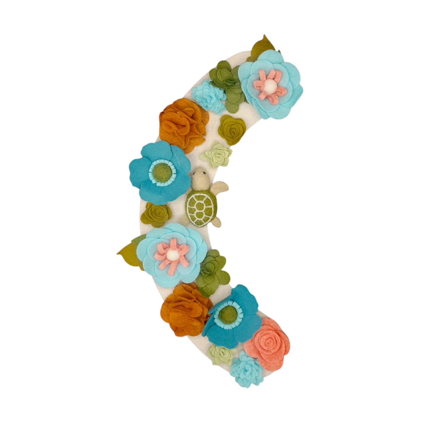 With vibrant teal, green, brown felt flowers and felted sea turtle are evoking a coastal vibe and symbolizing ocean habitats.