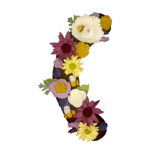 The Save the Bees wreath attachment is adorned with bumblebees and a wide variety of flowers they love! With shades of purple, yellow, and linen-colored flowers on a brown background. *A percentage of the proceeds will go towards protecting these little pollinators.