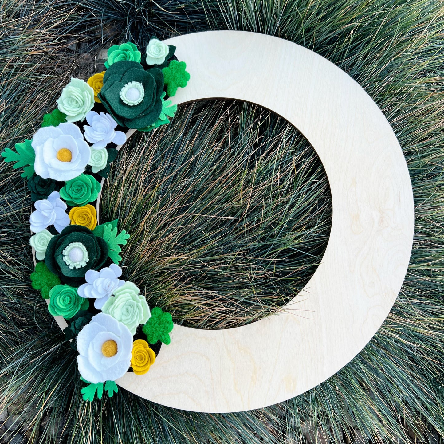 Celebrate the luck of the Irish with the St. Patrick's Day Wreath Attachment, a charming addition to your festive decor. This wreath features a beautiful array of felt flowers in green, white, and gold, capturing the spirit and joy of the holiday.