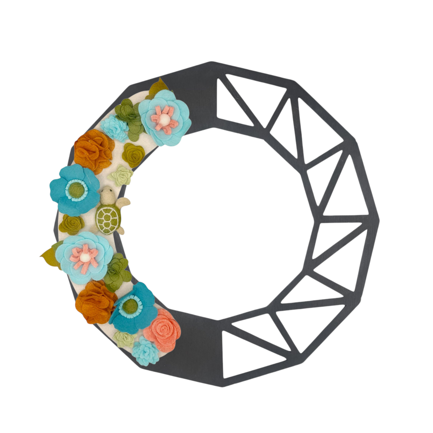 This wreath beautifies your door while raising awareness for the protection of sea turtles and their environment. Shown on the black geometric wreath base.