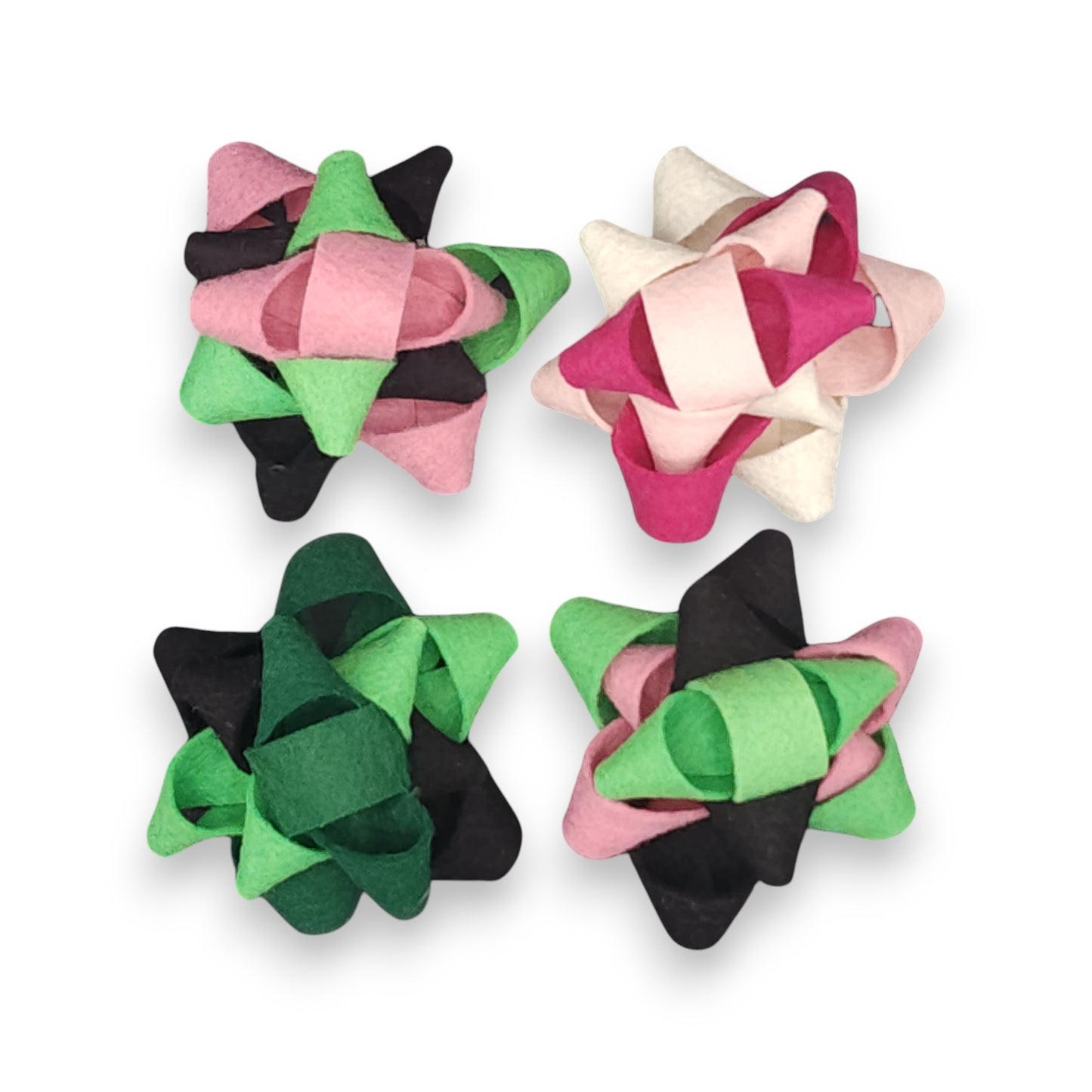 Wicked movie-inspired reusable gift bows featuring a Glinda bow in pink and white and an Elphaba bow in green and black, crafted from eco-friendly felt.