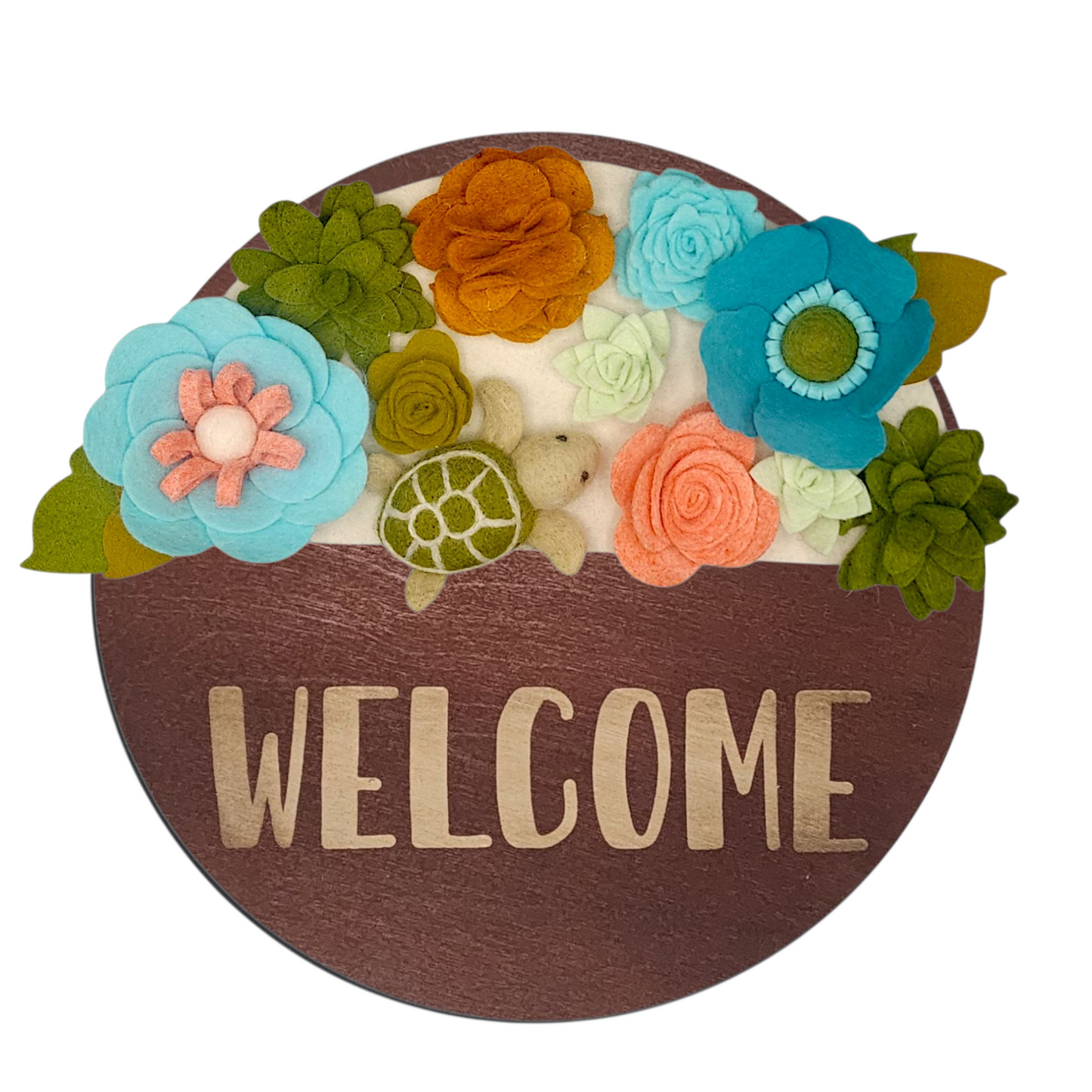 Beachy wreath attachment with blue, turquoise, and green flowers framing a sea turtle centerpiece on a sand-toned background.