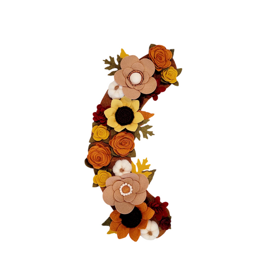 The Autumn wreath attachment is covered in sunflowers, pumpkins, and other autumn-colored flowers on a brown background.