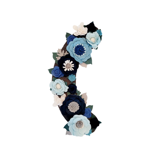 The Winter wreath attachment is covered in frost-bitten flowers in different shades of blue on a grey background.