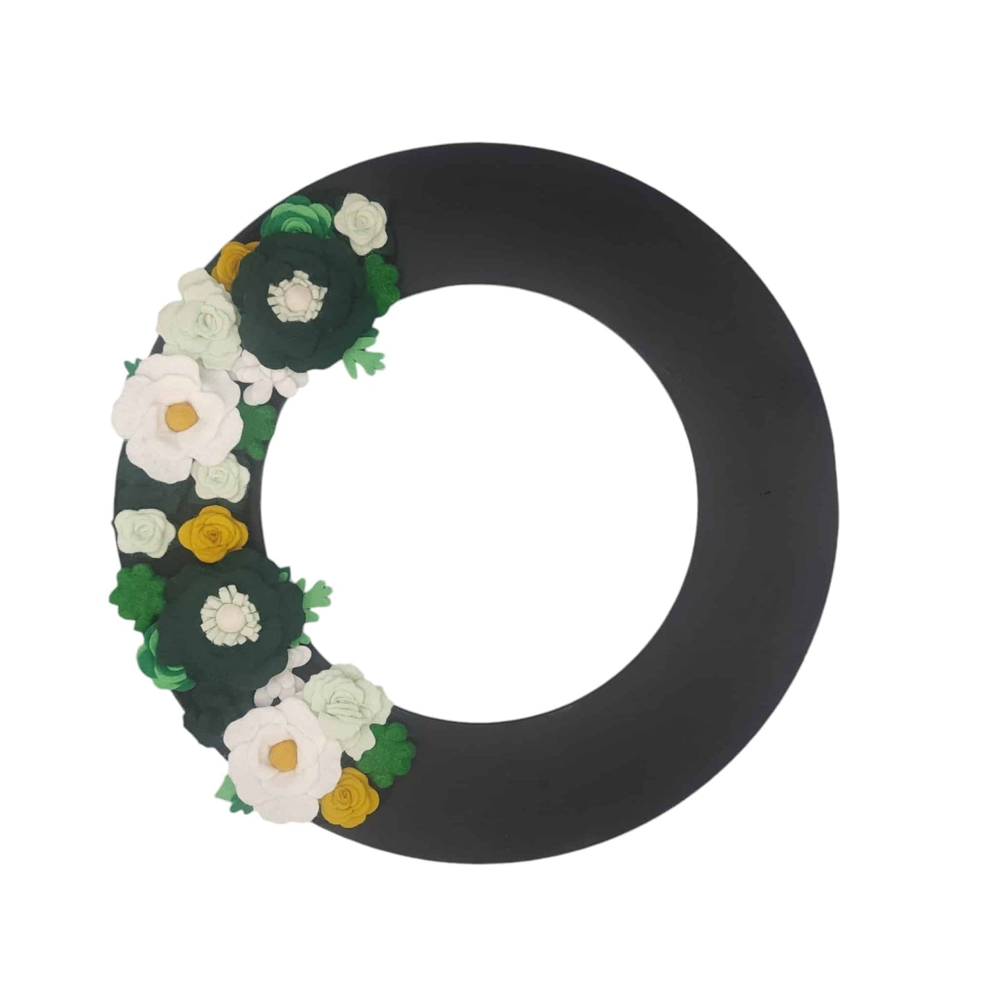 The lush greens and crisp white and green wool felt flowers create a fresh, lively look perfect for spring.