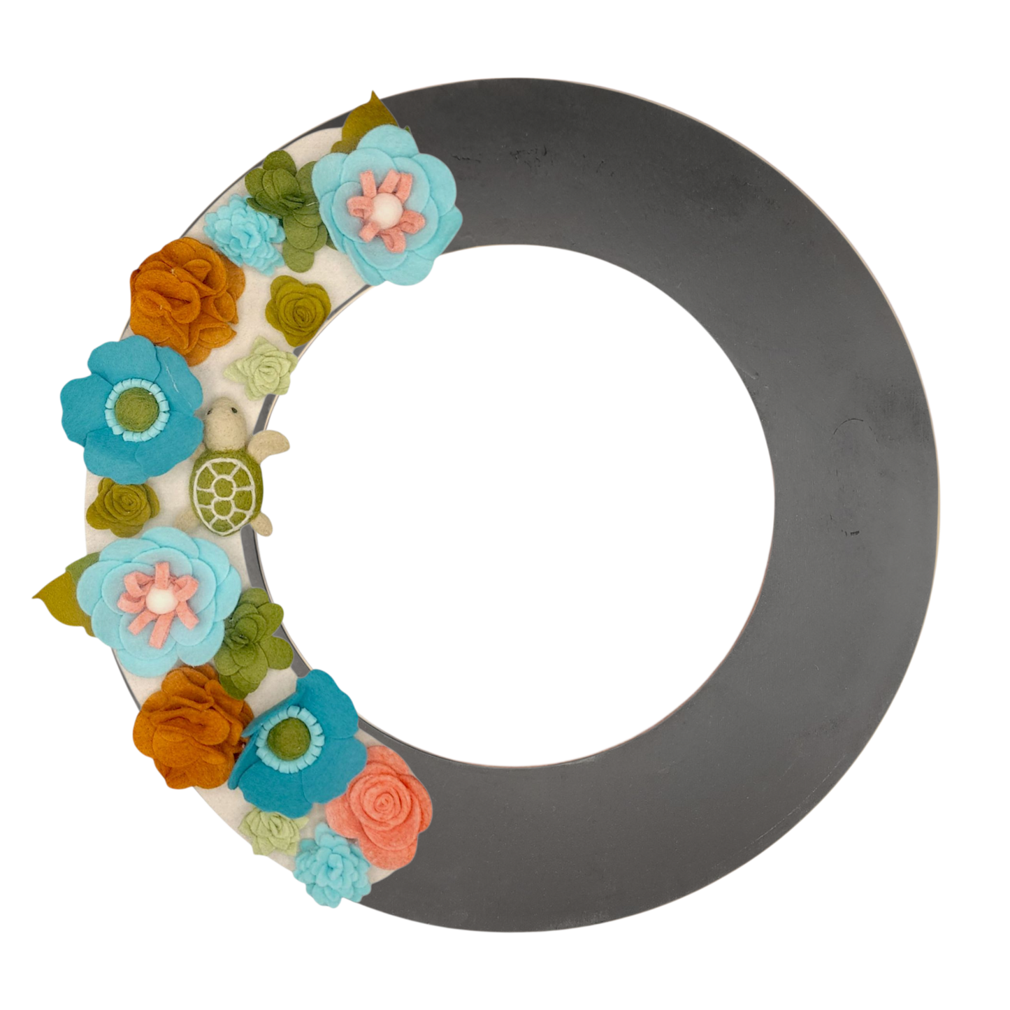 An eco-friendly wreath supporting the "Save the Sea Turtles" cause, featuring bright teal, blue, green, and orange felt flowers on a tan background featured on the black wreath base.