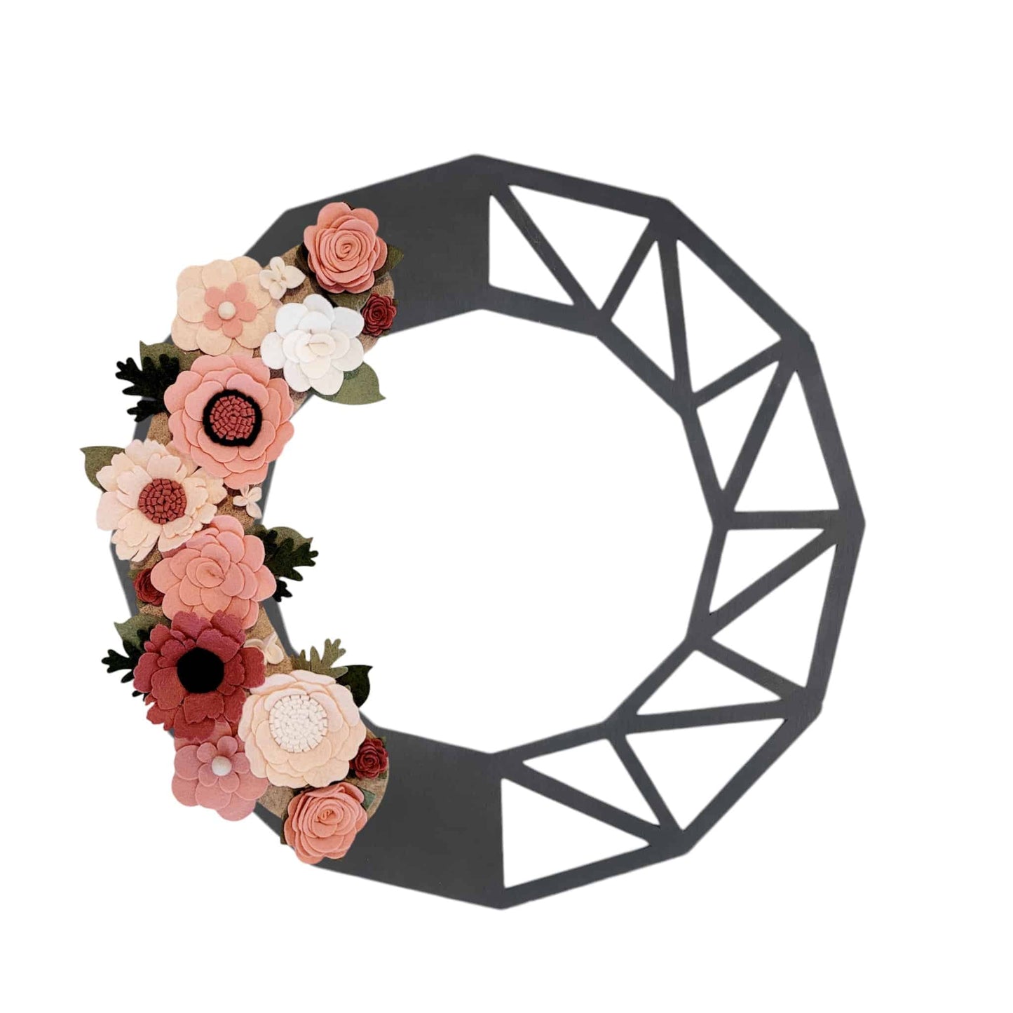 The Spring | Standard Wreath Attachment is a decorative piece, crafted from a black metal frame forming an abstract, partially open circle with geometric angles. One side flaunts colorful Eco-Fi felt flowers in shades of pink, red, and white, accented by green leaves. This handmade attachment utilizes recycled materials to create a visually appealing contrast.