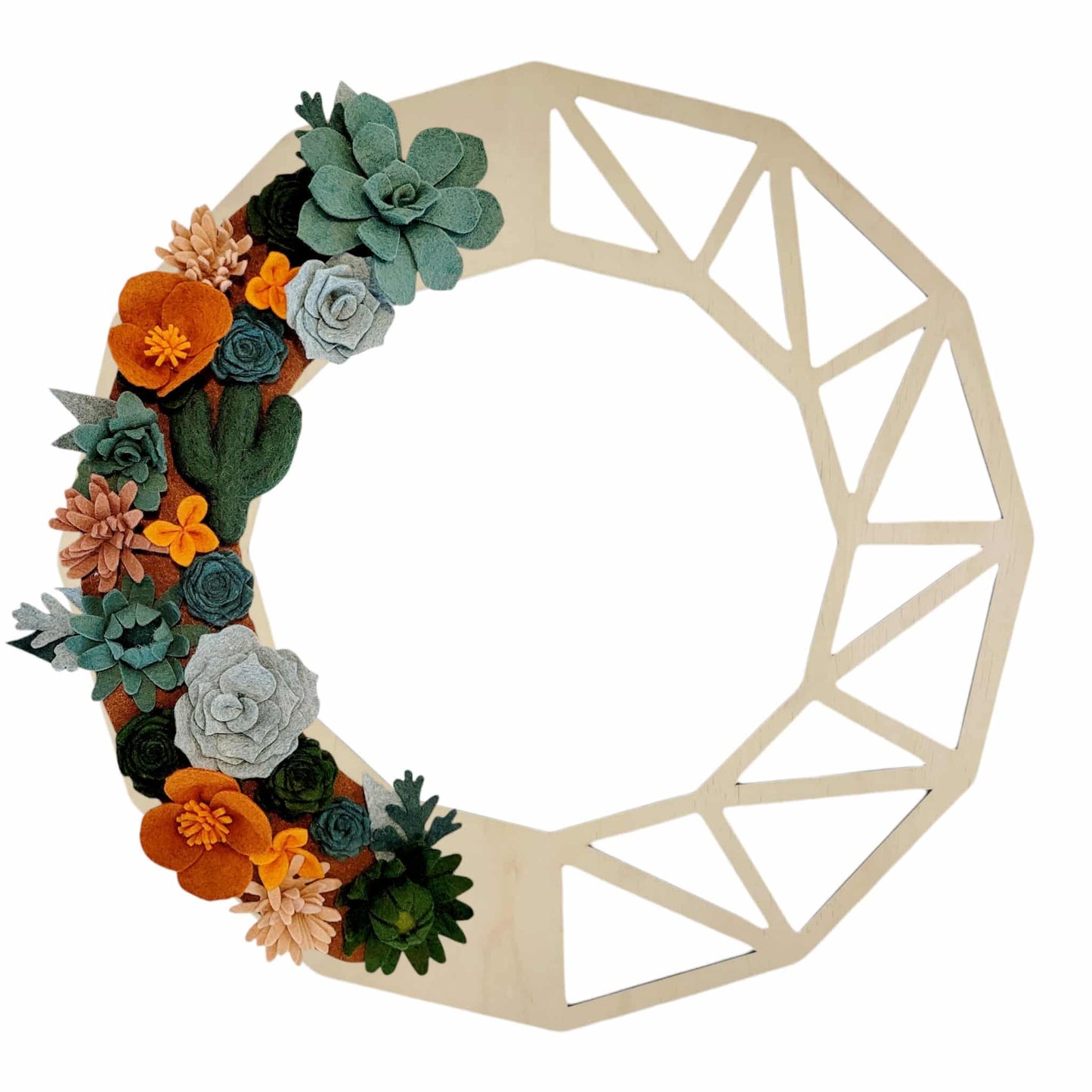 A vibrant wreath with felt cacti, wildflower blooms, and dried grasses on a birch geometric wreath base, capturing Arizona's desert charm.
