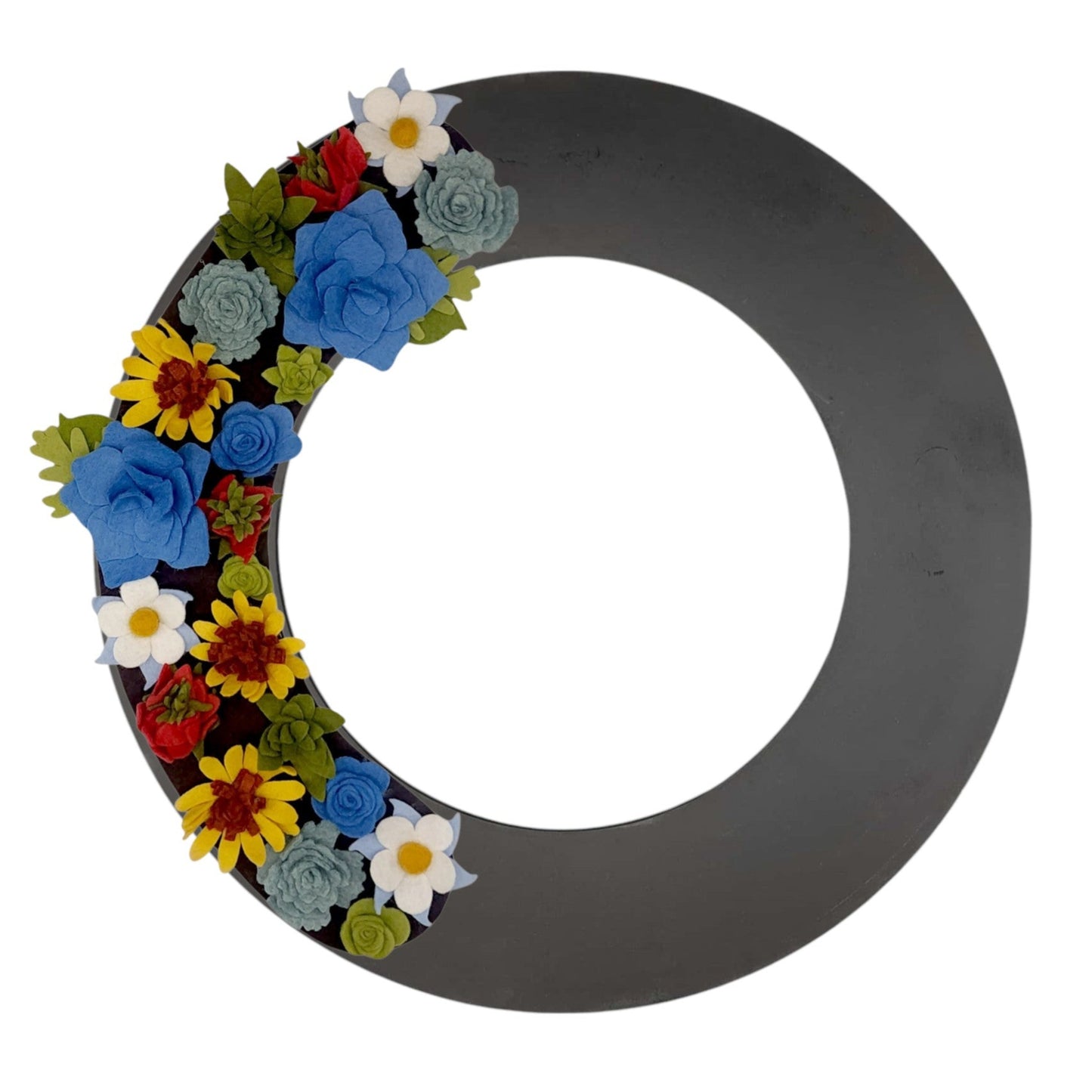 A colorful wreath of Colorado wildflowers, including columbines and sunflowers, arranged on a black base with greenery accents.