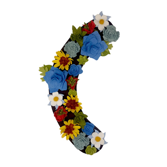 Custom, interchangeable, eco-friendly, Colorado wildflower wreath attachment is covered in daisies, succulents, Columbine and Indian paintbrush flowers on a brown background.- ADORND Décor