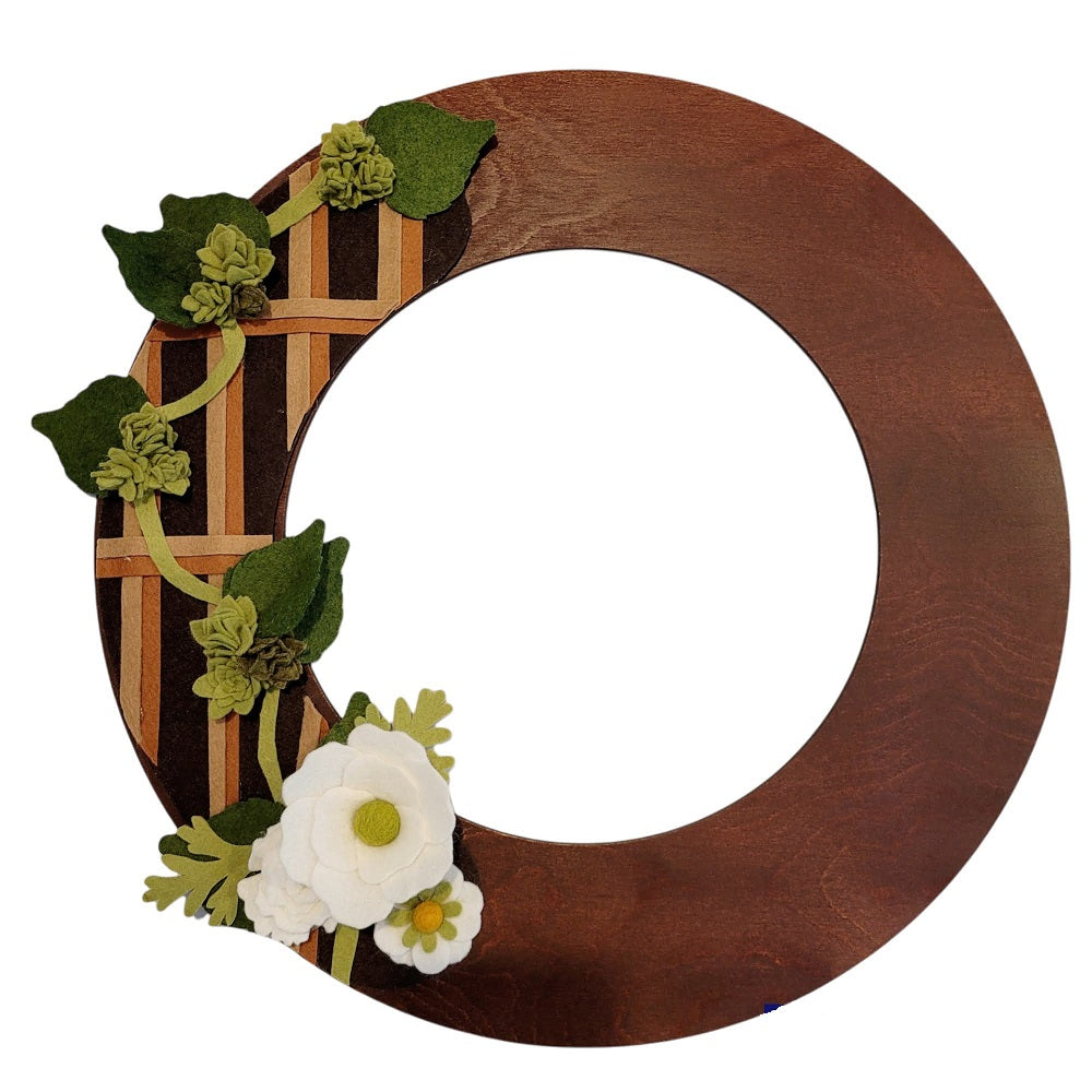An eco-friendly door wreath with a felt trellis design featuring lush faux beer hops vines on a walnut wreath base.