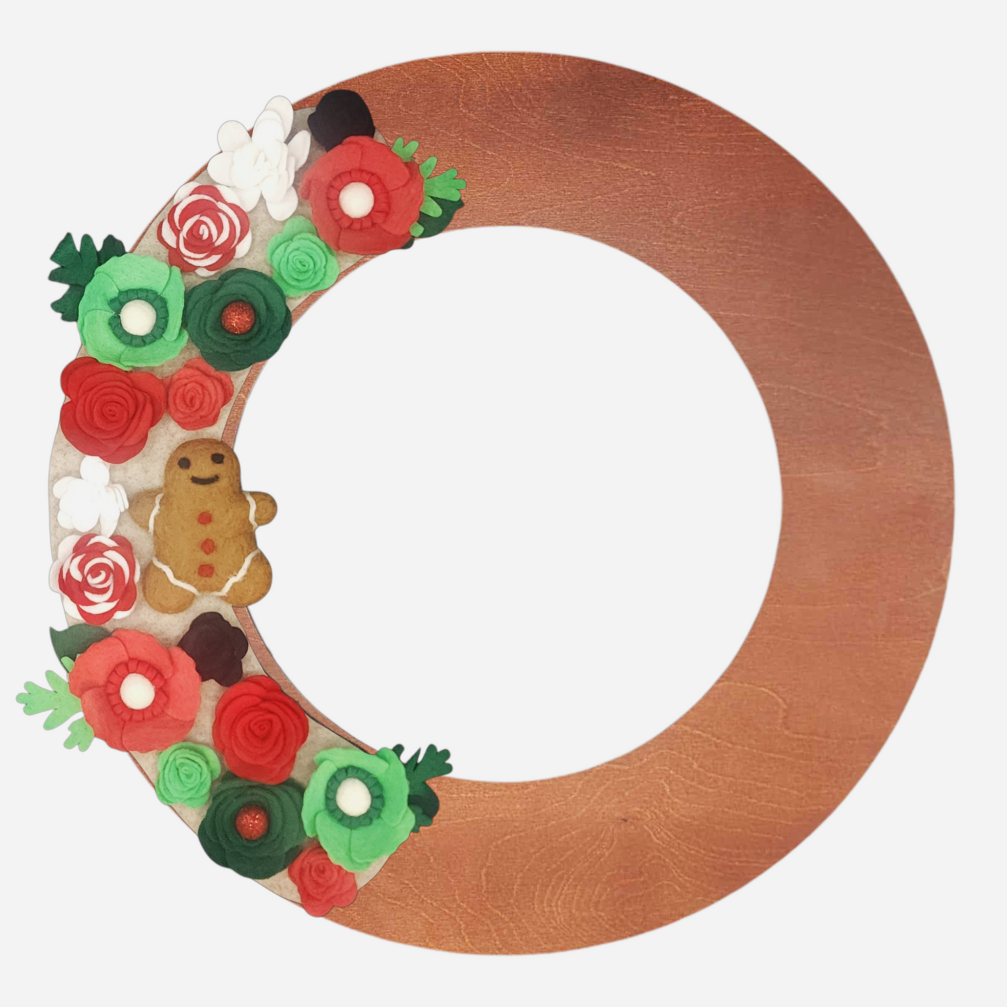 Festive, eco-friendly santa wreath with candy cane-style flowers, bright whimsical green and red accents, and a gingerbread ornament set on a beige backdrop on a walnut wreath.