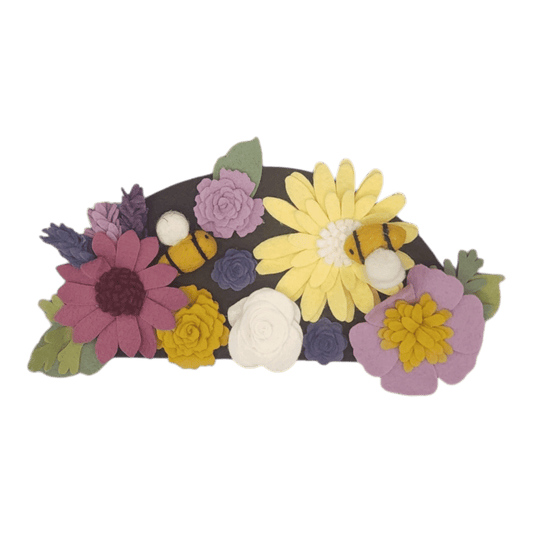 Wreath attachment with bumblebees and colorful flowers in purple, yellow, and linen on a brown background, supporting pollinator protection.