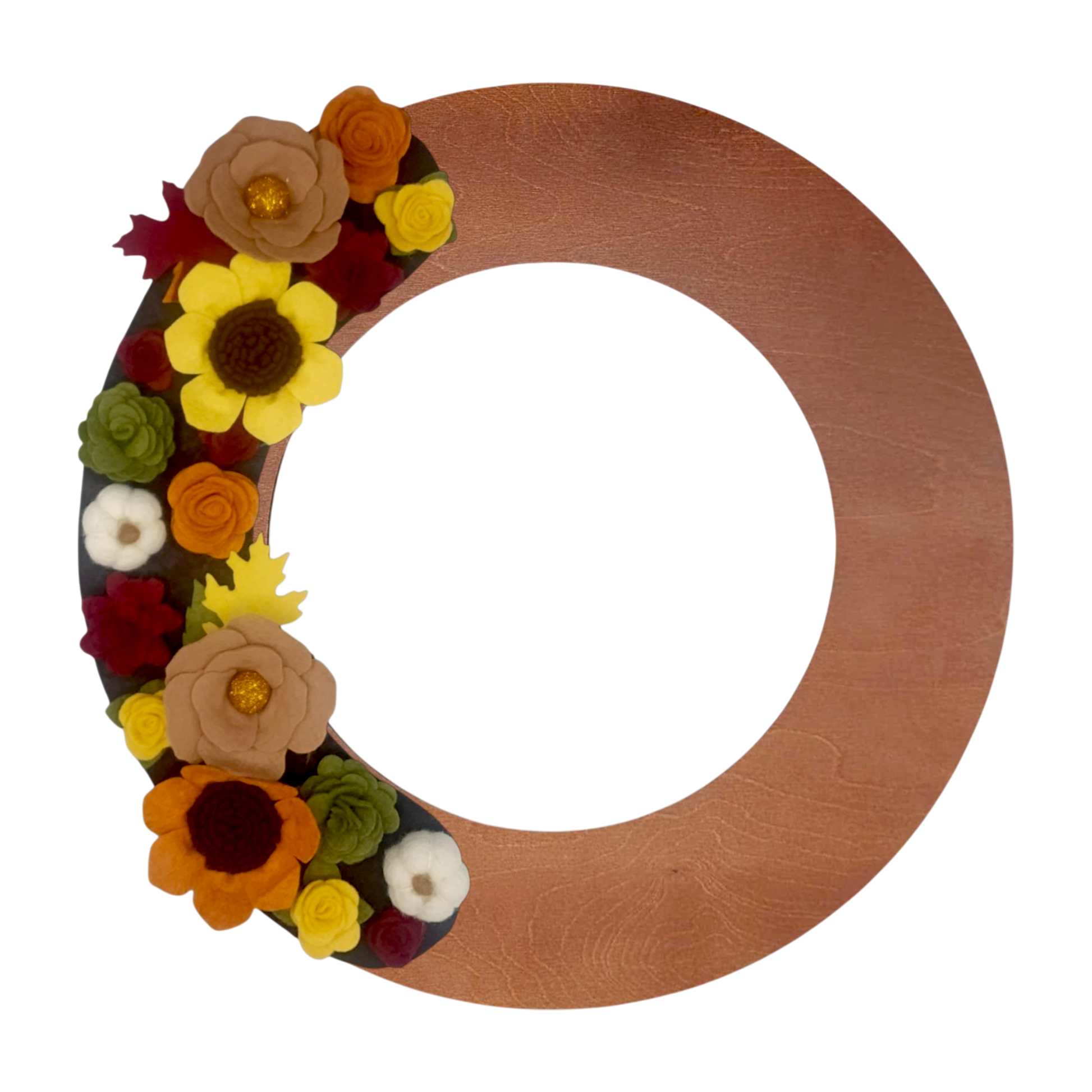 A decorative wreath featuring vibrant sunflowers, pumpkins, and assorted autumn-hued flowers set on a deep brown backdrop on a walnut wreath base