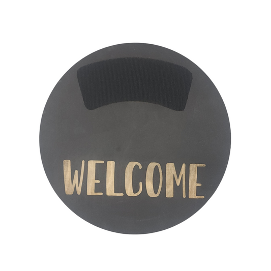 11" circular wreath base in color black with "WELCOME" laser etched below velcro for attachments.