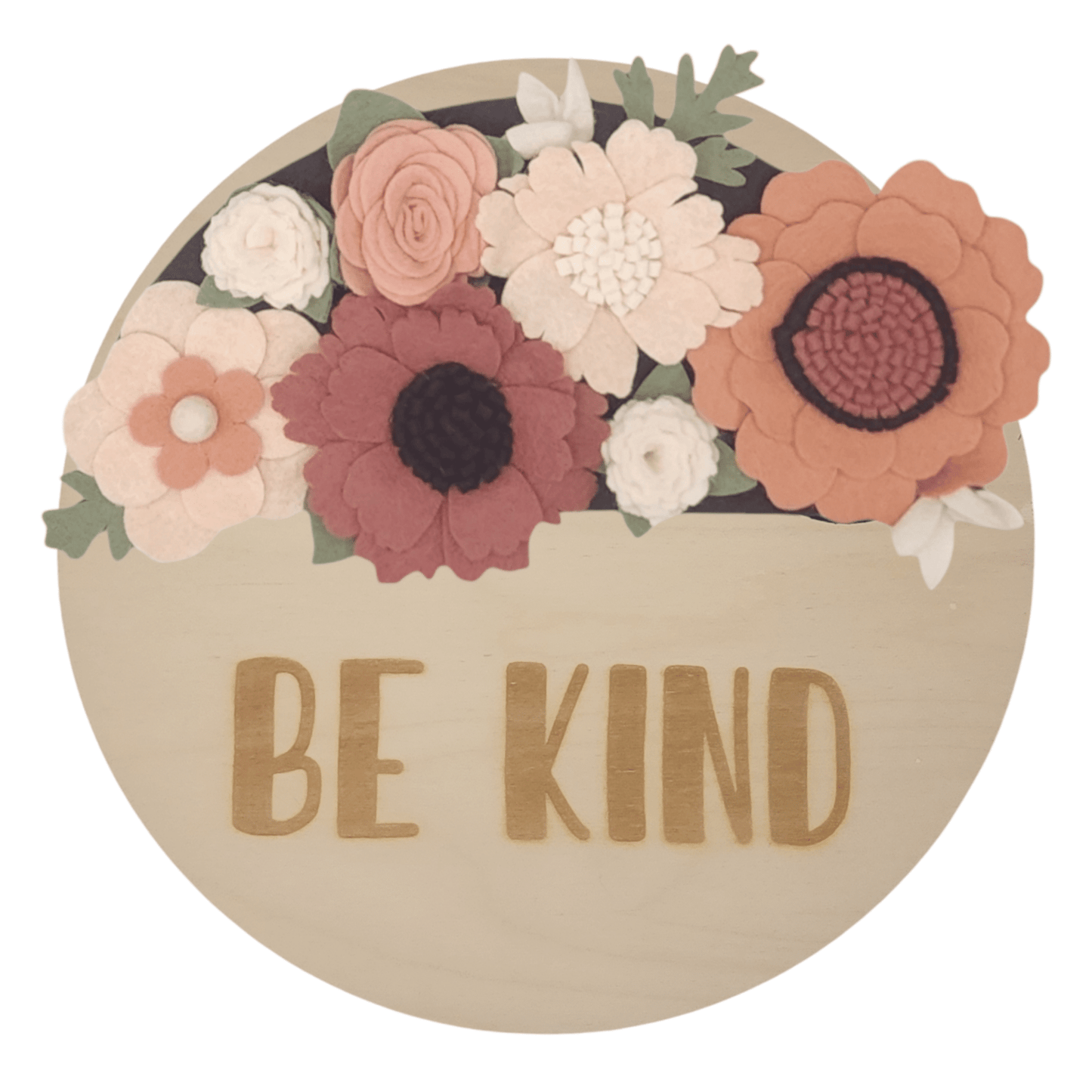 Spring wreath featuring felt flowers in variation of pink and white on a round birch base reading "BE KIND".