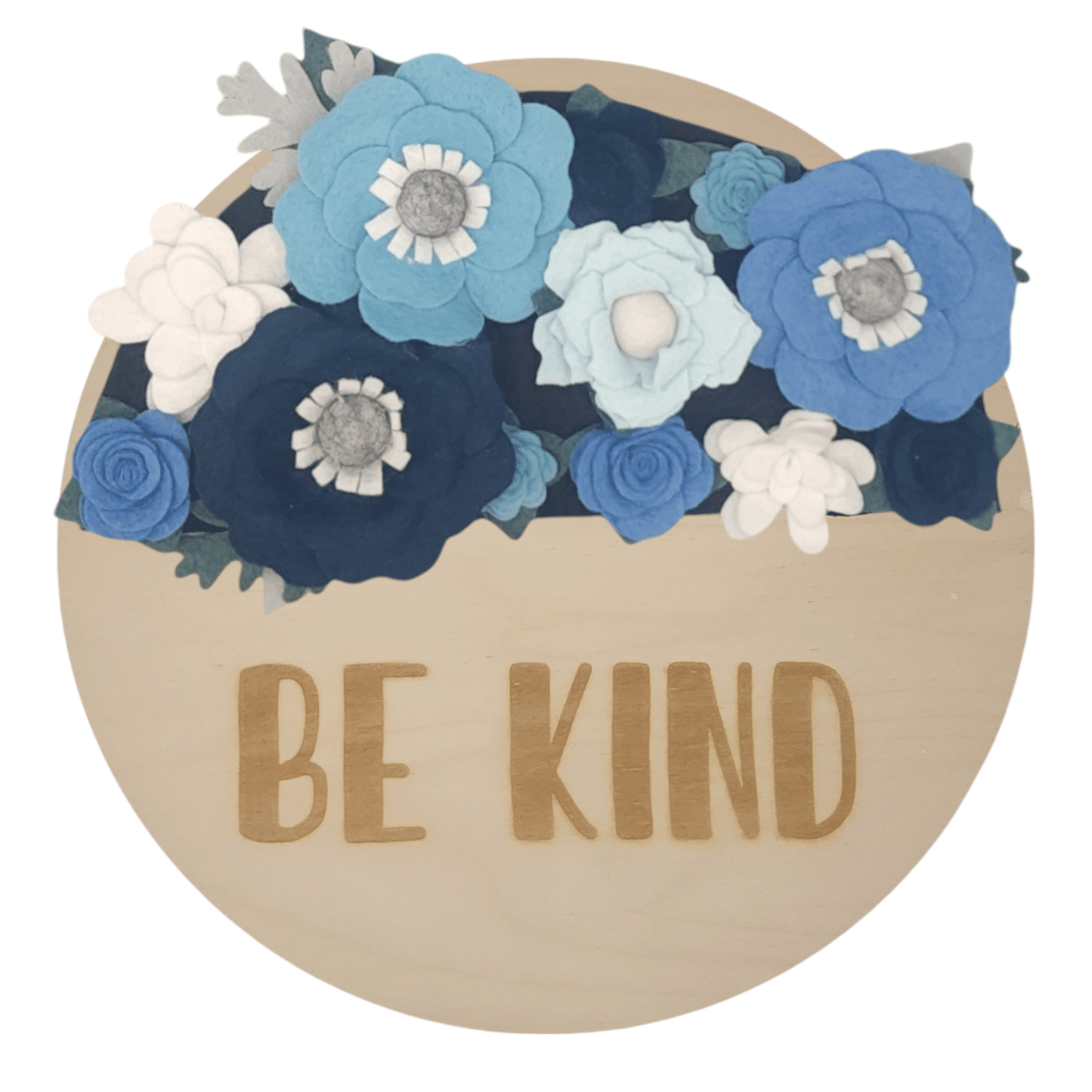 Winter wreath is a winter wonderland of blue and white felt flowers on a round birch base reading "BE KIND".