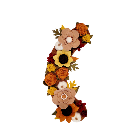 The Autumn wreath attachment is covered in sunflowers, pumpkins, and other autumn-colored flowers on a brown background. 