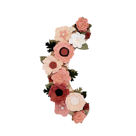 The Spring wreath attachment is full of pink, blush, and linen flowers on a beige background. 