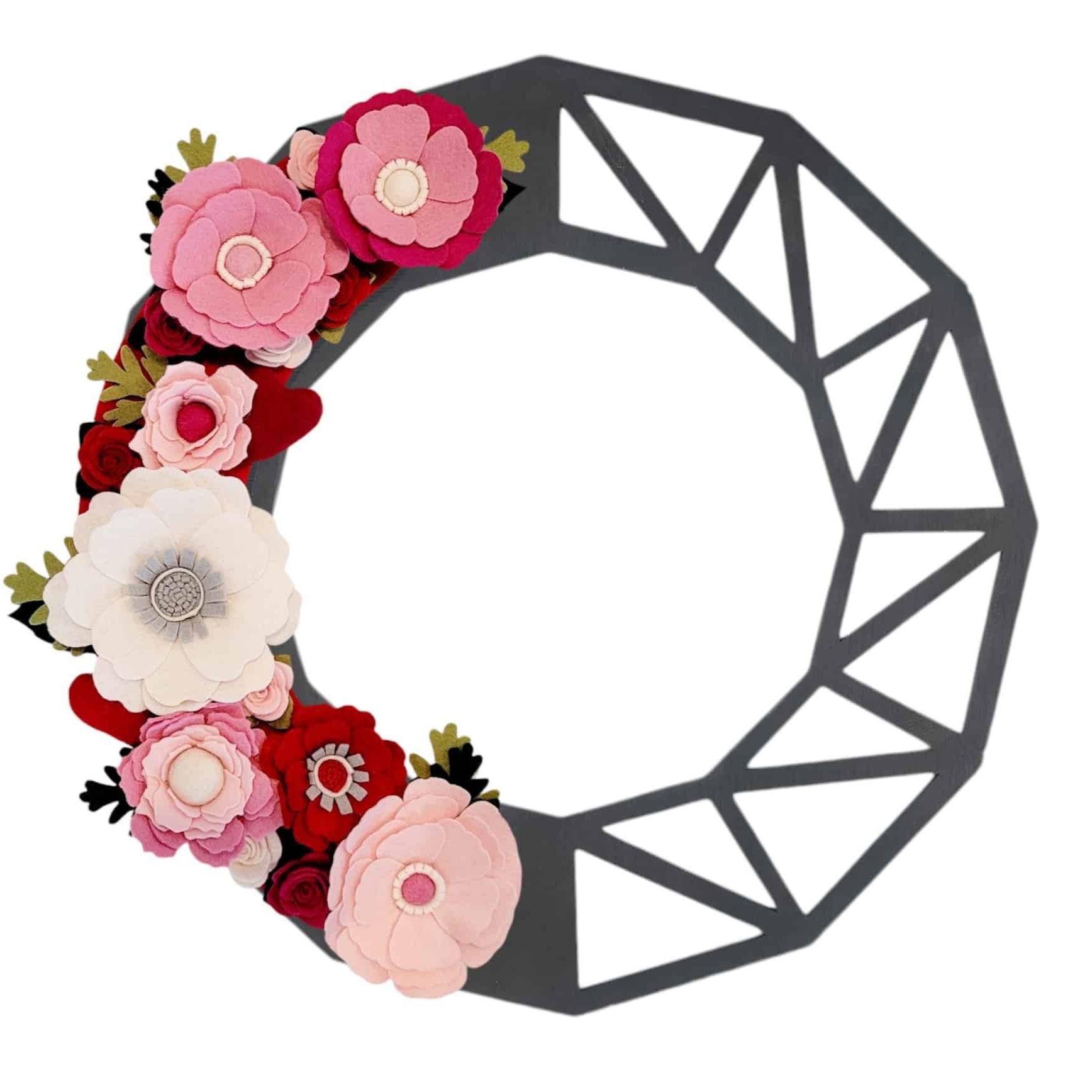 This lovely Valentine’s Day wreath features an array of wool felt flowers in beautiful shades of pink, creating a soft and romantic aesthetic set on a black modern wreath.