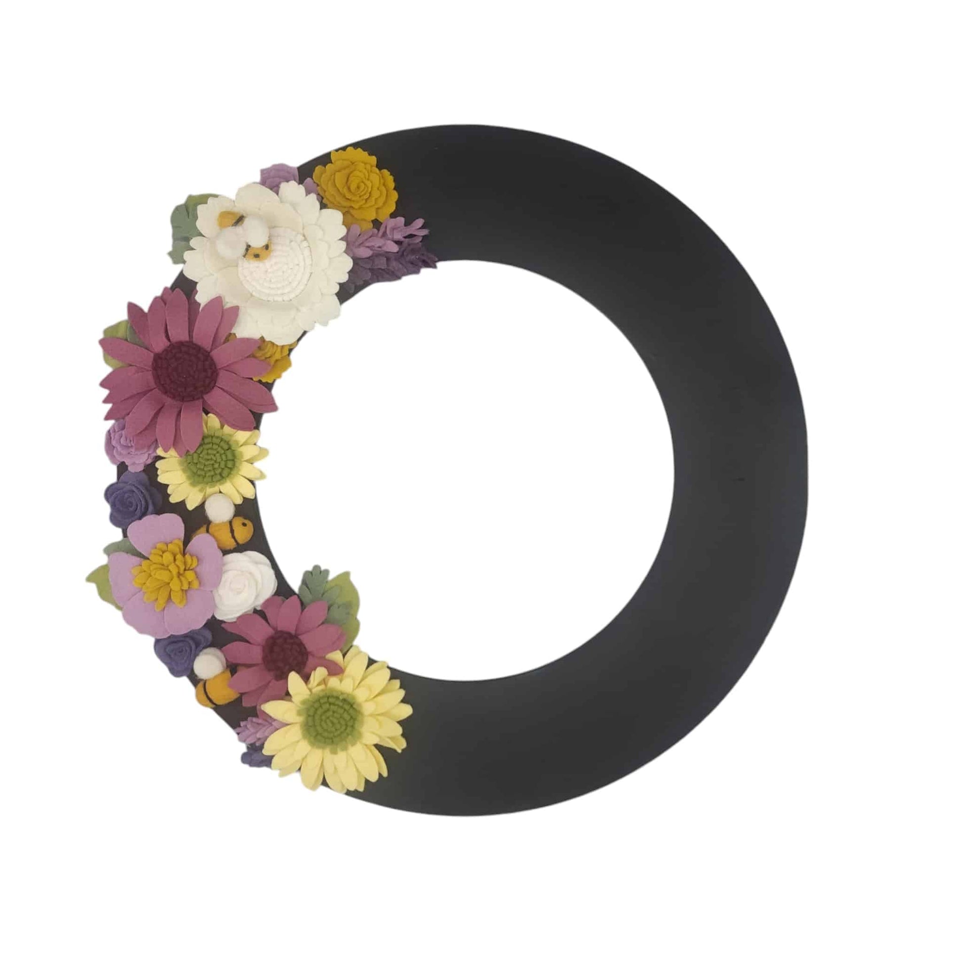 A whimsical wreath featuring felt bees among vibrant purple and yellow flowers contrasting on the black wreath base.