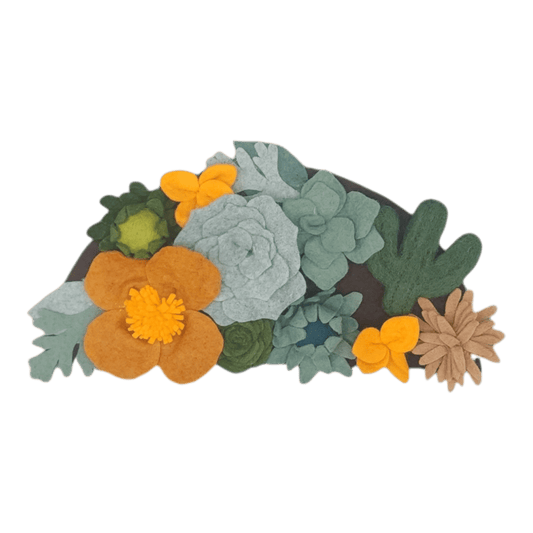 A felt arrangement of various succulents and flowers, including cacti, in shades of green, yellow, and brown on a dark background.