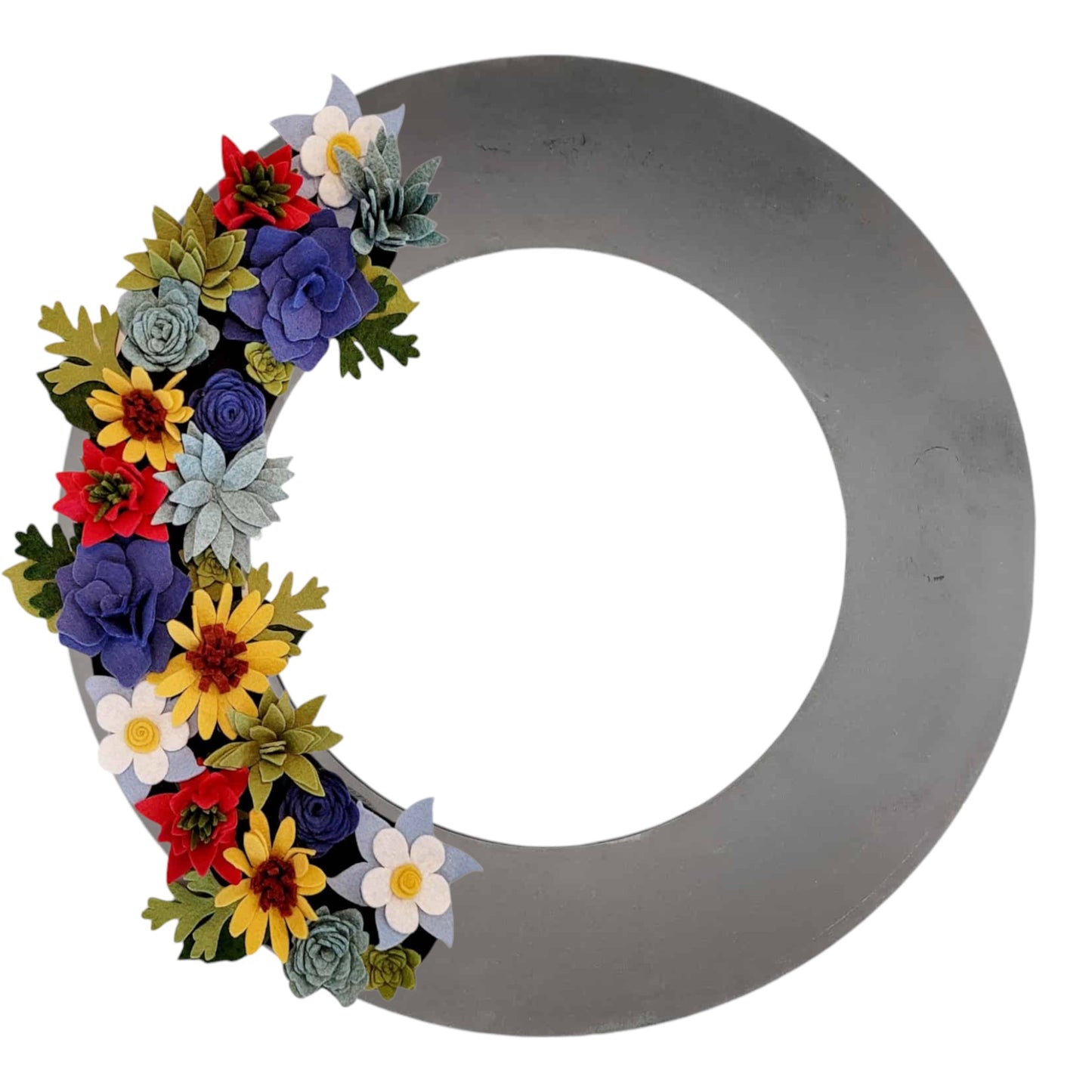 A colorful wreath of Colorado wildflowers, including columbines and sunflowers, arranged on a black base with greenery accents.