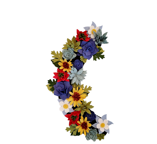 Custom, interchangeable, eco-friendly, Colorado wildflower wreath attachment is covered in daisies, succulents, Columbine and Indian paintbrush flowers on a brown background.- ADORND Décor