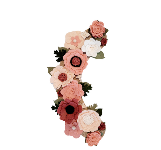 The Spring wreath attachment is full of pink, blush, and linen flowers on a beige background. 