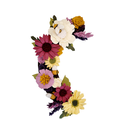 The Save the Bees wreath attachment is adorned with bumblebees and a wide variety of flowers they love! With shades of purple, yellow, and linen-colored flowers on a brown background. *A percentage of the proceeds will go towards protecting these little pollinators.